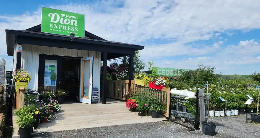 Magasin de plantes Jardin Dion Express avec fleurs colorées et panneaux.